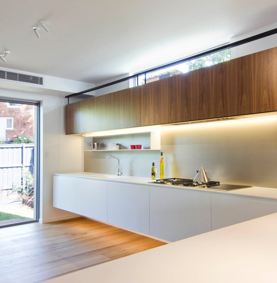 Photo of a scandinavian l-shaped open plan kitchen in Sydney with quartz benchtops.