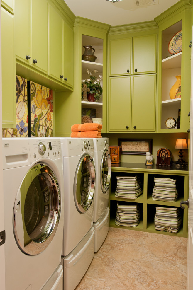 Photo of an eclectic laundry room in Little Rock with green cabinets and beige floor.