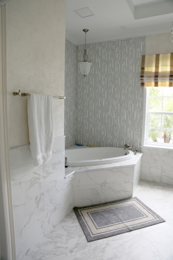Inspiration for a large mediterranean master bathroom in Miami with flat-panel cabinets, white cabinets, a corner tub, a corner shower, a two-piece toilet, white tile, marble, white walls, marble floors, an undermount sink, quartzite benchtops, white floor, a hinged shower door and white benchtops.