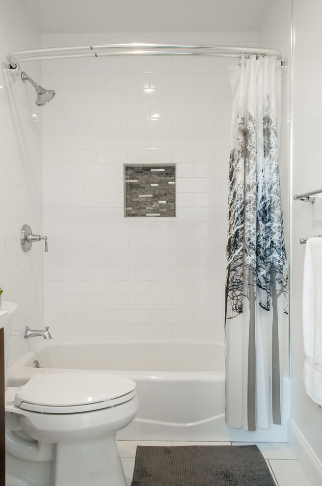 Small transitional kids bathroom in New York with a drop-in tub, a two-piece toilet, white tile, subway tile, white walls, porcelain floors, white floor and a shower curtain.