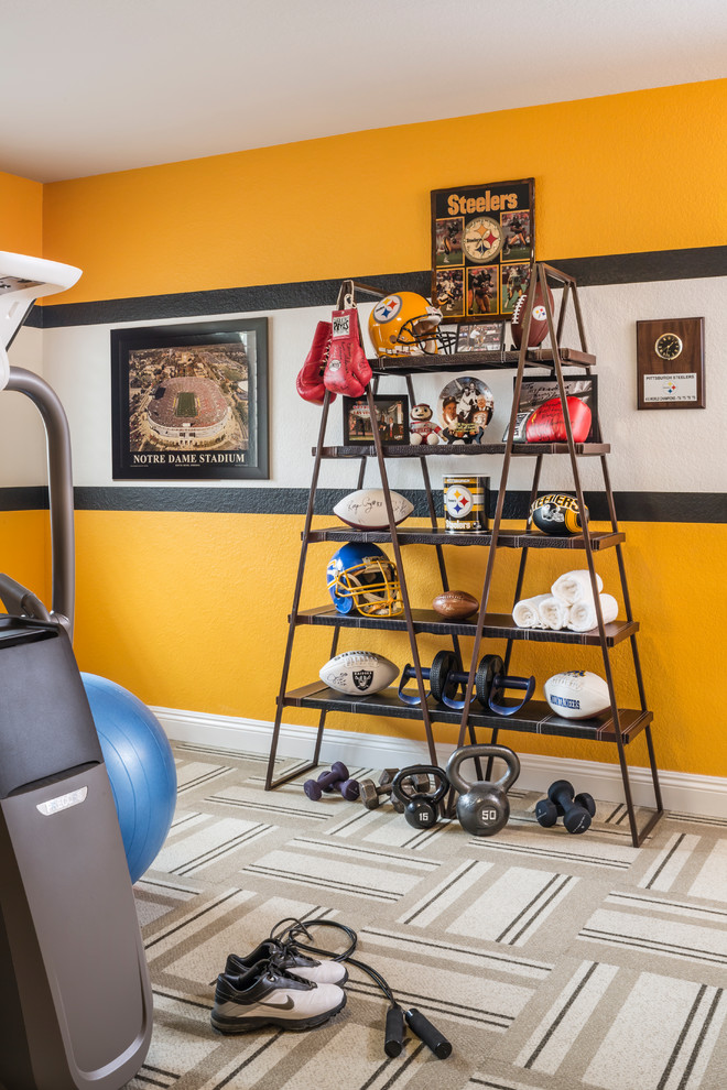 This is an example of a mid-sized traditional multipurpose gym in Las Vegas with yellow walls and carpet.