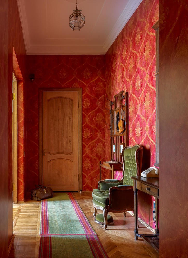 Mid-sized midcentury hallway in Moscow with red walls, medium hardwood floors and beige floor.
