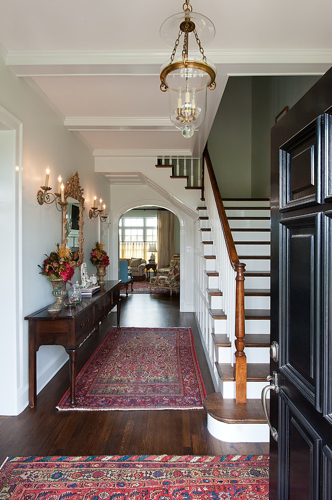 Photo of a mid-sized traditional foyer in Dallas with white walls, dark hardwood floors, a single front door and a black front door.