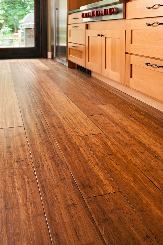 Inspiration for a mid-sized transitional u-shaped bamboo floor eat-in kitchen remodel in Boston with an undermount sink, shaker cabinets, medium tone wood cabinets, brown backsplash, stone tile backsplash, stainless steel appliances, green walls and an island