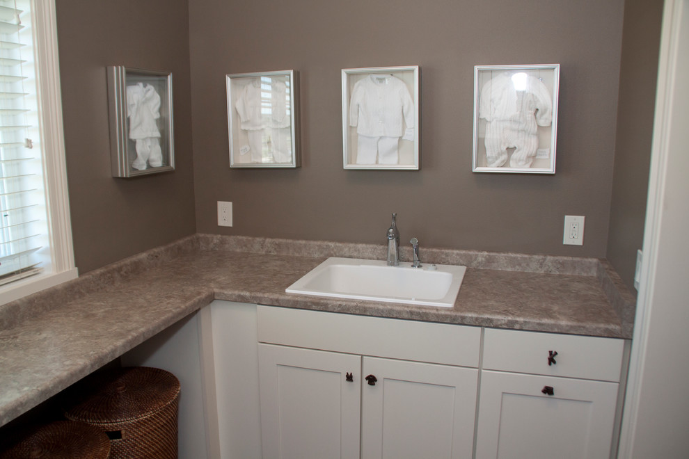 This is an example of a transitional laundry room in Milwaukee.