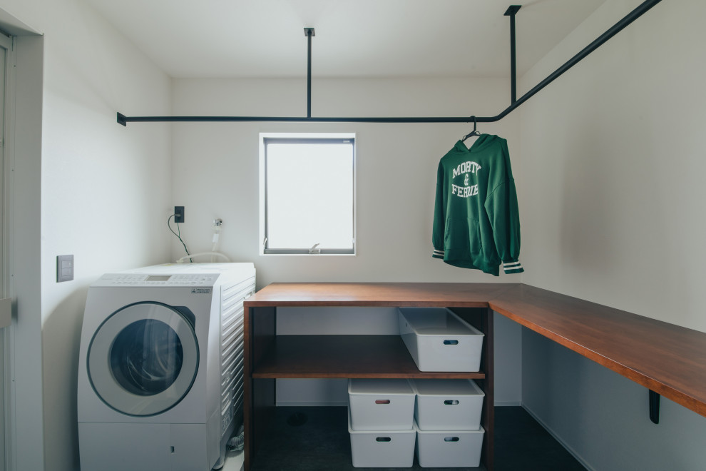 Photo of a contemporary l-shaped laundry room in Other with brown cabinets, white walls, wallpaper and wallpaper.