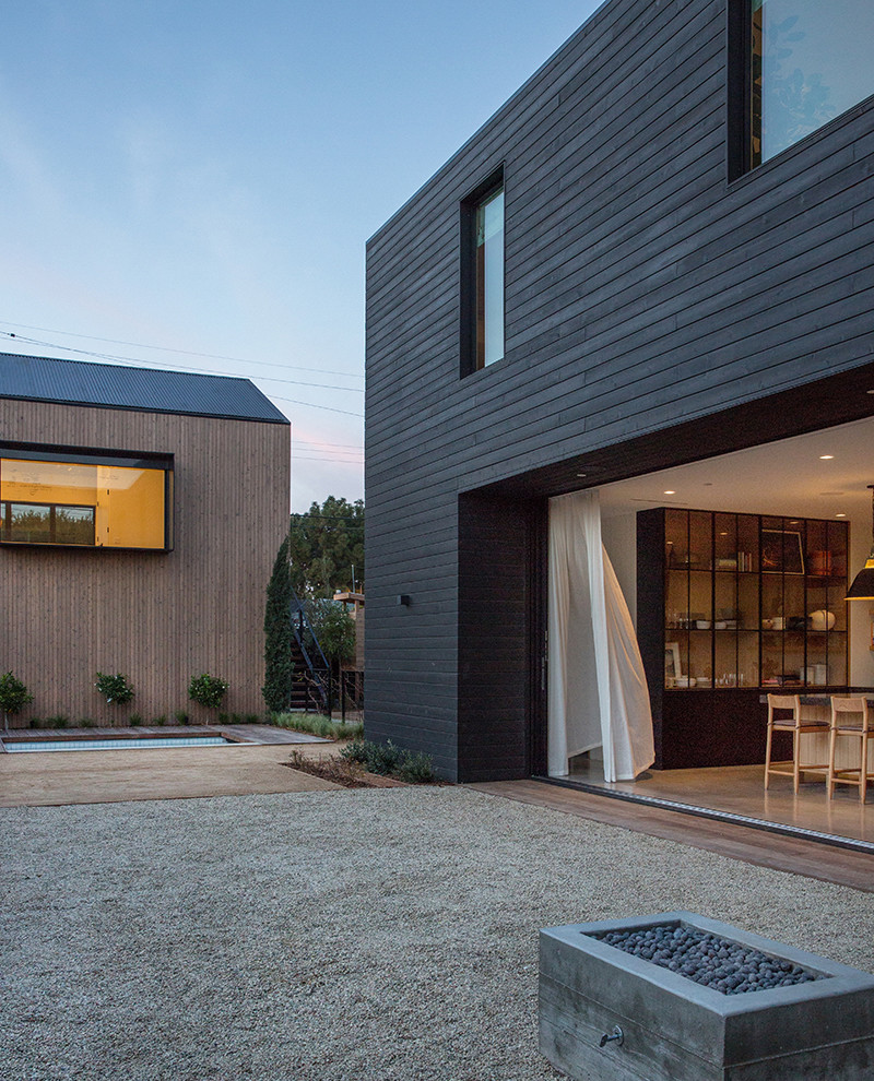 This is an example of a scandinavian two-storey black house exterior in Los Angeles.
