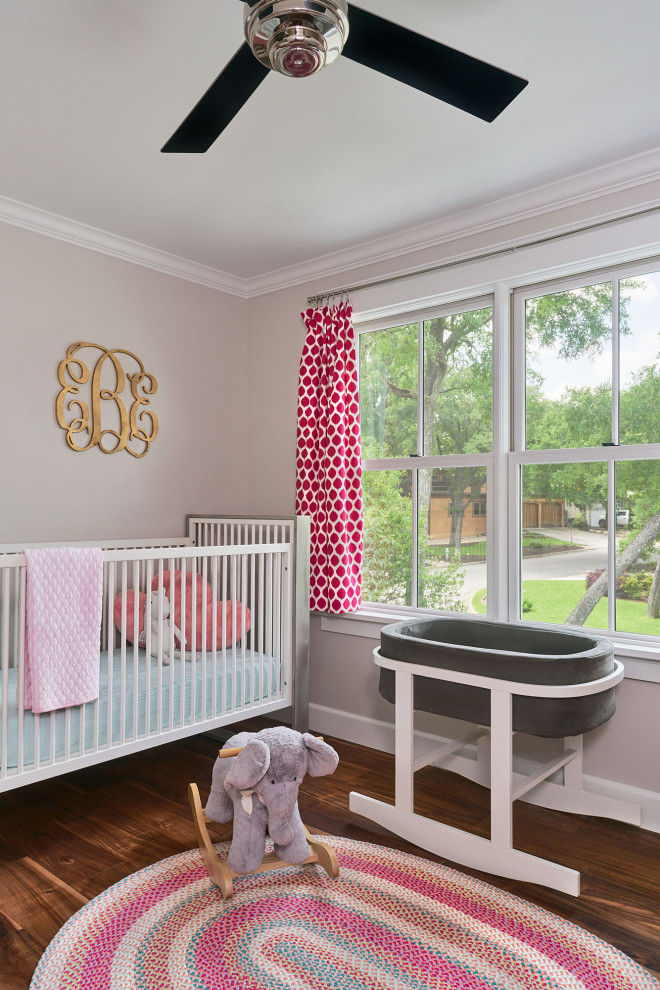 Design ideas for a small traditional nursery in Austin with grey walls and medium hardwood floors.