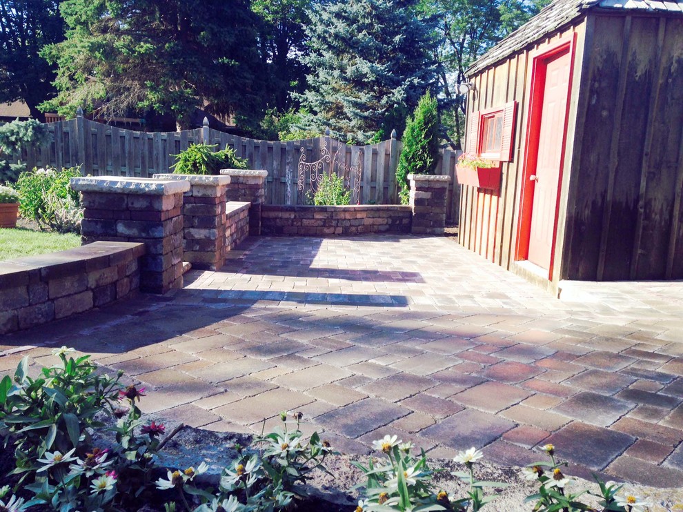 Photo of a small mediterranean patio in Milwaukee with brick pavers.