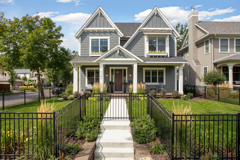 Inspiration for a mid-sized transitional two-storey grey house exterior in Minneapolis with mixed siding, a gable roof, a shingle roof, a black roof and clapboard siding.