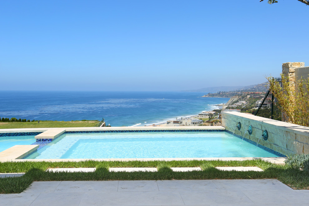 Backyard rectangular hot tub photo in Orange County