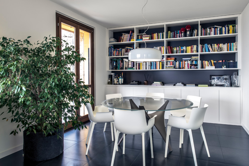 Design ideas for a contemporary dining room in Milan with white walls, slate floors, black floor and no fireplace.