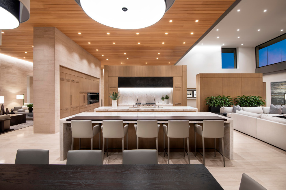 Photo of an expansive contemporary open plan kitchen in Phoenix with a submerged sink, flat-panel cabinets, light wood cabinets, quartz worktops, integrated appliances, limestone flooring, multiple islands, white worktops and a wood ceiling.