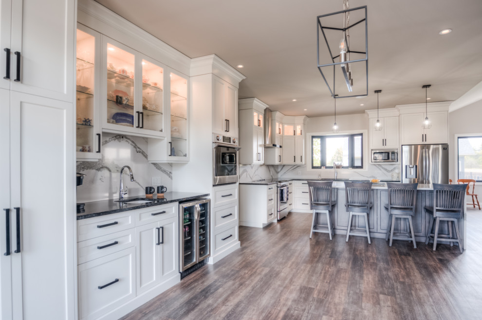 Transitional eat-in kitchen photo with shaker cabinets, white cabinets, stainless steel appliances and an island