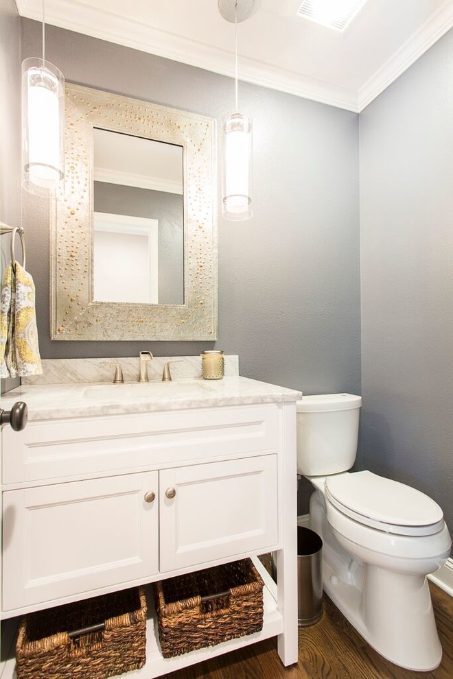 Inspiration for a large transitional powder room in Denver with shaker cabinets, white cabinets, a two-piece toilet, white tile, grey walls, dark hardwood floors, an undermount sink and marble benchtops.