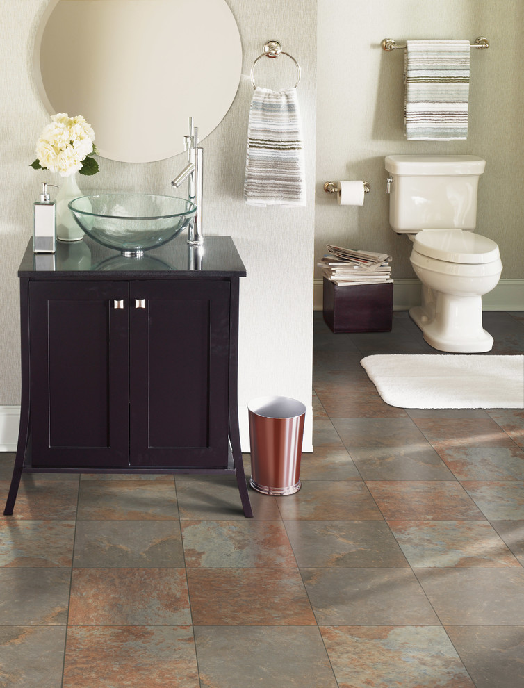 Inspiration for a large transitional 3/4 travertine floor and brown floor bathroom remodel with shaker cabinets, black cabinets, a two-piece toilet, white walls, a vessel sink and quartz countertops