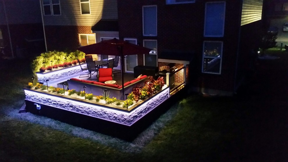 Large trendy backyard deck photo with no cover
