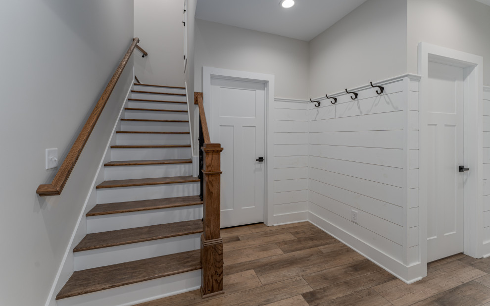 Medium sized country wood l-shaped mixed railing staircase in Atlanta with painted wood risers and wainscoting.