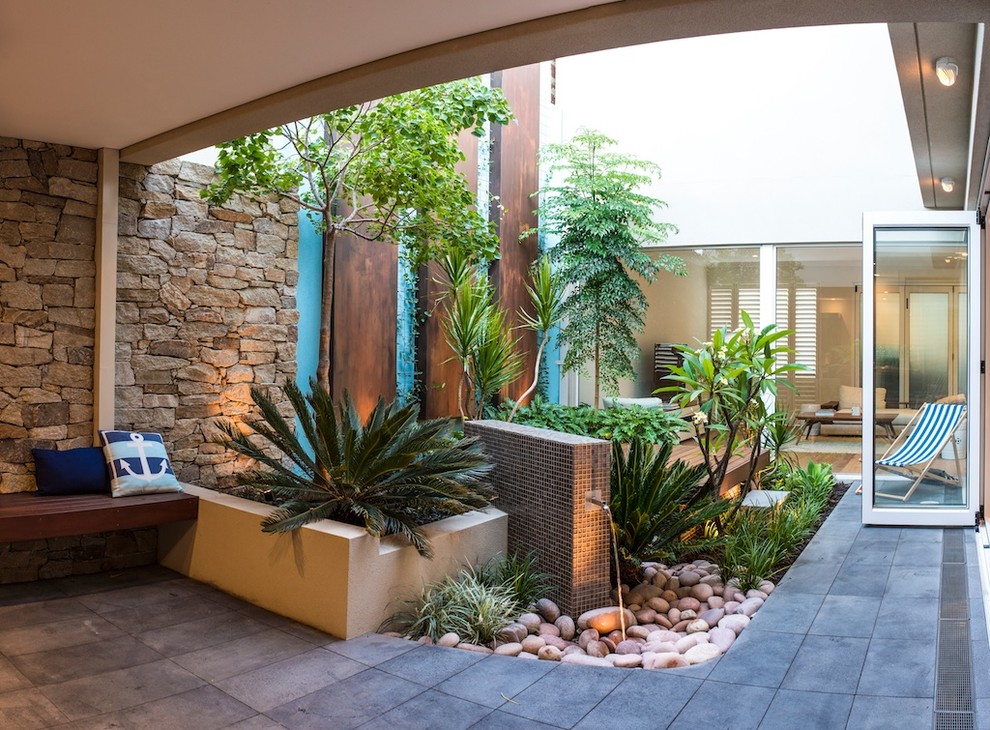 Design ideas for a small contemporary courtyard patio in Perth with natural stone pavers.