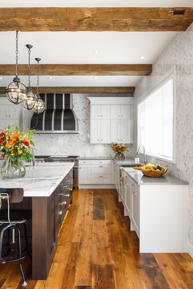 Photo of an expansive traditional u-shaped eat-in kitchen in Ottawa with a farmhouse sink, shaker cabinets, dark wood cabinets, marble benchtops, white splashback, mosaic tile splashback, panelled appliances, medium hardwood floors and with island.