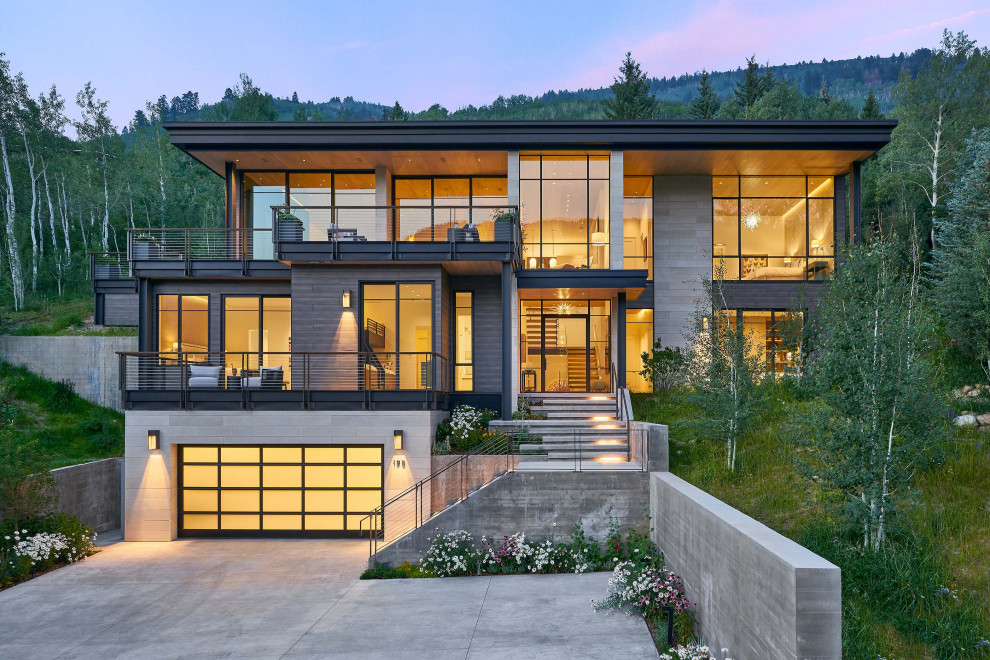 Inspiration for a contemporary three-storey house exterior in Denver with a flat roof.