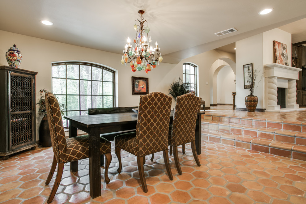 Large mediterranean open plan dining in Dallas with beige walls, terra-cotta floors and no fireplace.