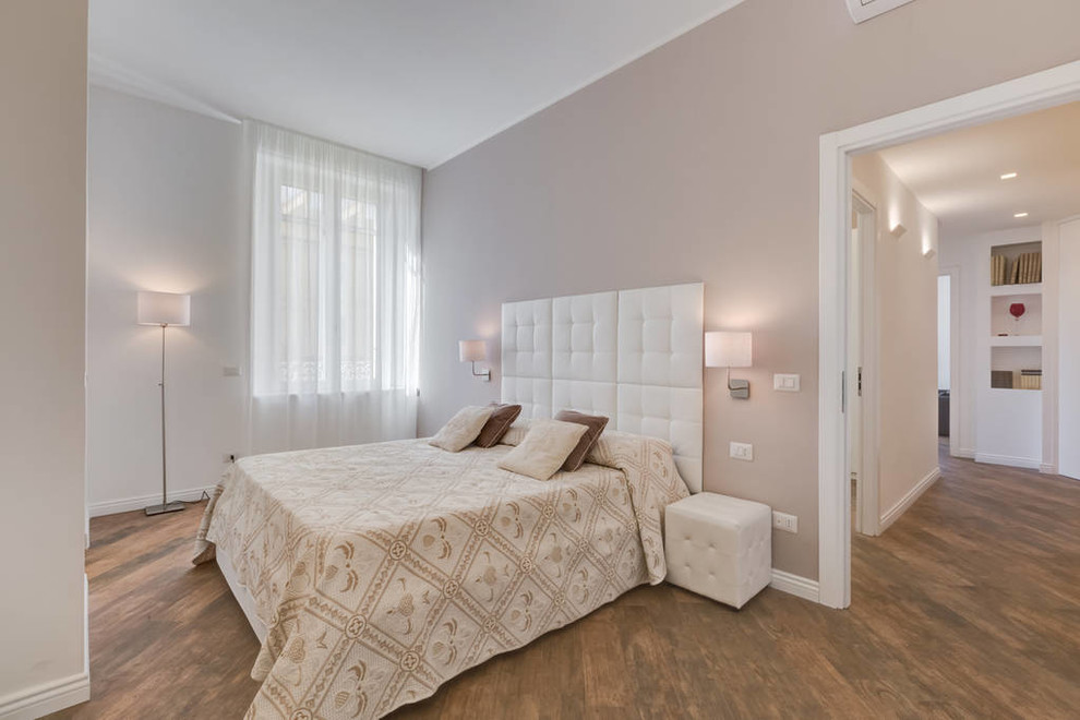 Inspiration for a mid-sized transitional master bedroom in Rome with beige walls and dark hardwood floors.