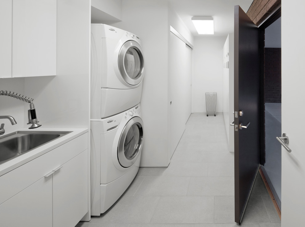 Modern laundry room in Phoenix with a drop-in sink and white cabinets.