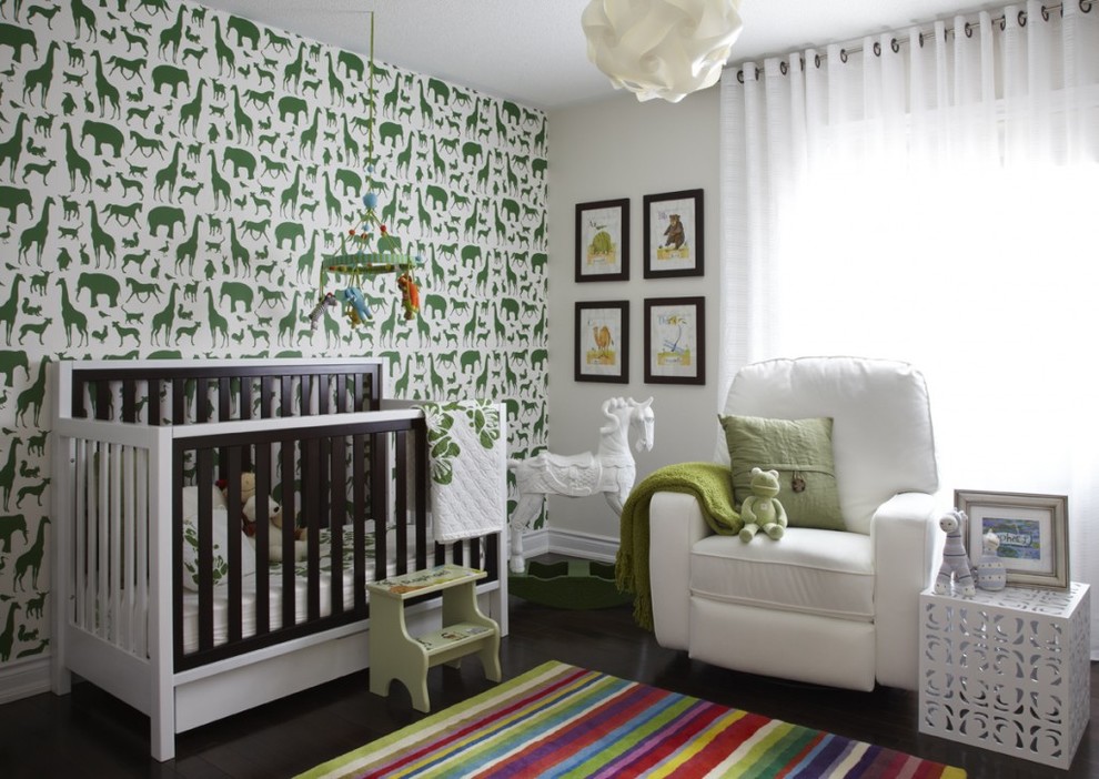 Photo of a mid-sized contemporary gender-neutral nursery in Toronto with multi-coloured walls, dark hardwood floors and brown floor.