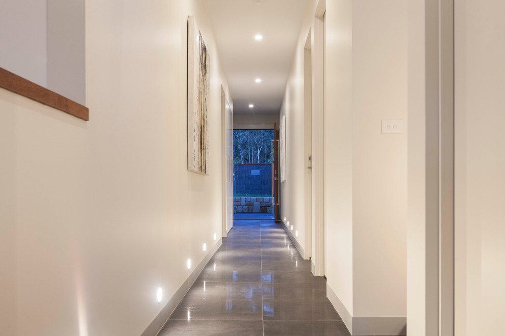 Inspiration for a mid-sized contemporary hallway in Canberra - Queanbeyan with white walls and porcelain floors.