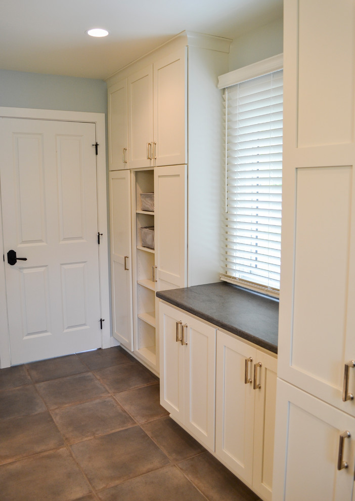 Mid-sized transitional laundry room in Other with flat-panel cabinets, white cabinets, solid surface benchtops, blue walls, ceramic floors, grey floor and grey benchtop.