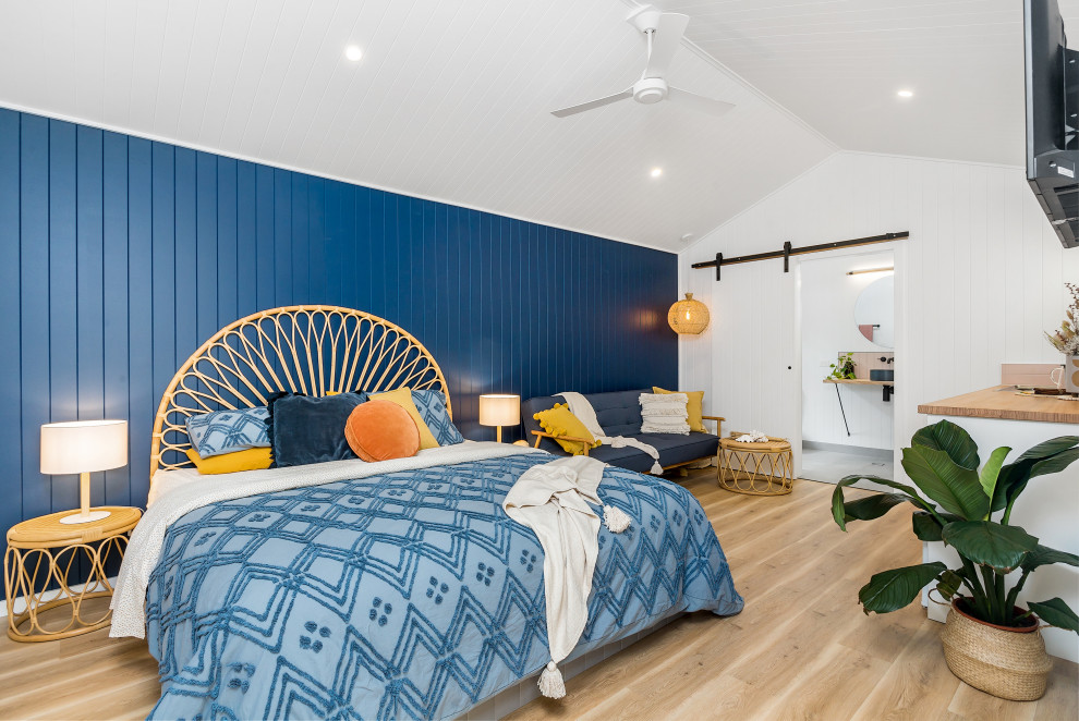 Inspiration for a large contemporary master bedroom in Sydney with blue walls, light hardwood floors and beige floor.