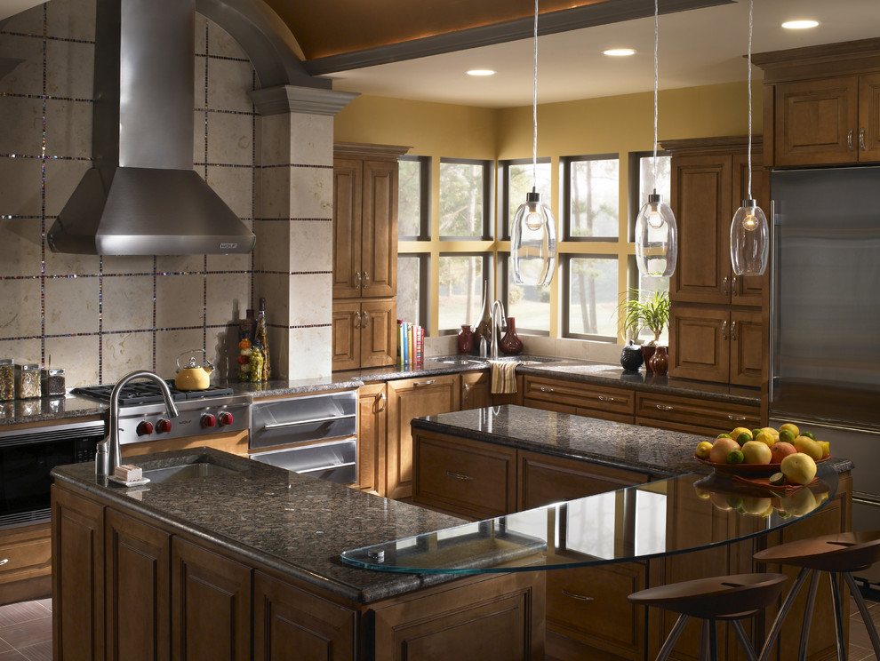 Example of a large transitional u-shaped kitchen design in Boston with an undermount sink, raised-panel cabinets, medium tone wood cabinets, quartz countertops, beige backsplash, porcelain backsplash, stainless steel appliances and an island