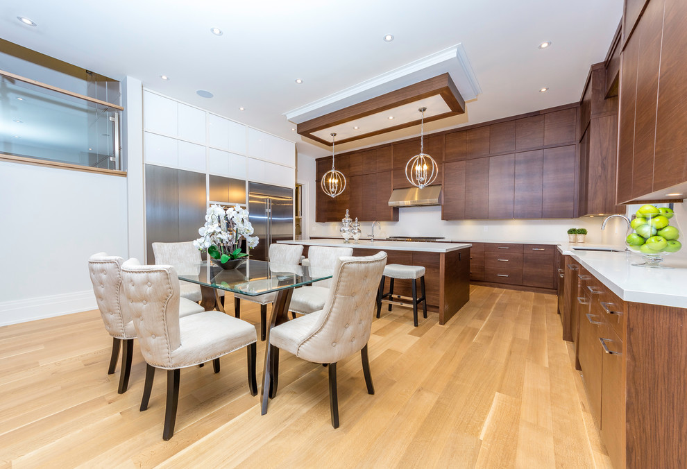 Mid-sized transitional l-shaped light wood floor and brown floor eat-in kitchen photo in Toronto with an undermount sink, flat-panel cabinets, medium tone wood cabinets, quartz countertops, white backsplash, stainless steel appliances and an island