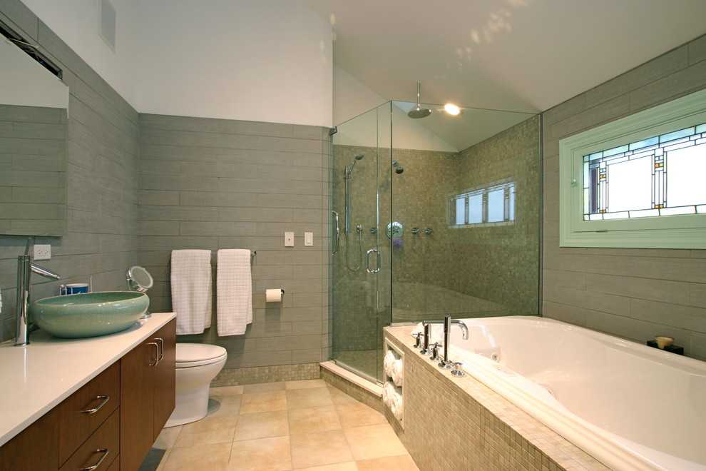 Inspiration for a large contemporary master bathroom in Boston with a vessel sink, flat-panel cabinets, medium wood cabinets, an alcove tub, a corner shower, a one-piece toilet, gray tile and white walls.