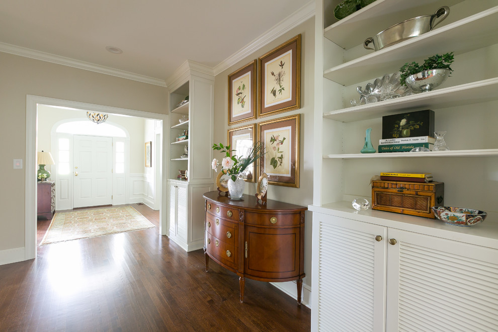 This is an example of a mid-sized contemporary entry hall with beige walls, medium hardwood floors, a single front door, a white front door and brown floor.