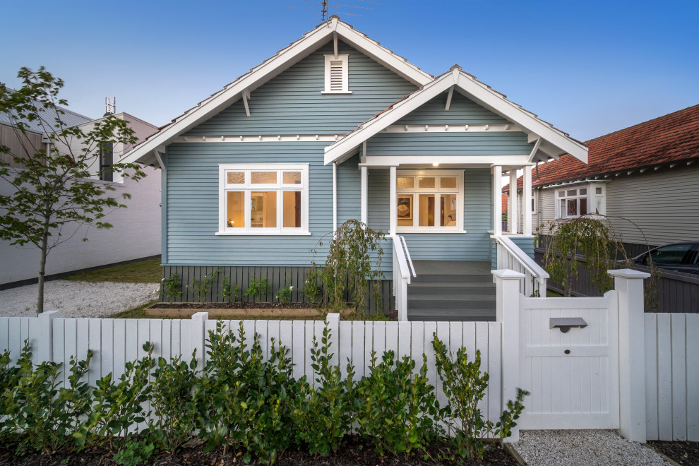 Inspiration for a mid-sized transitional one-storey blue house exterior in Auckland with a gable roof and a shingle roof.