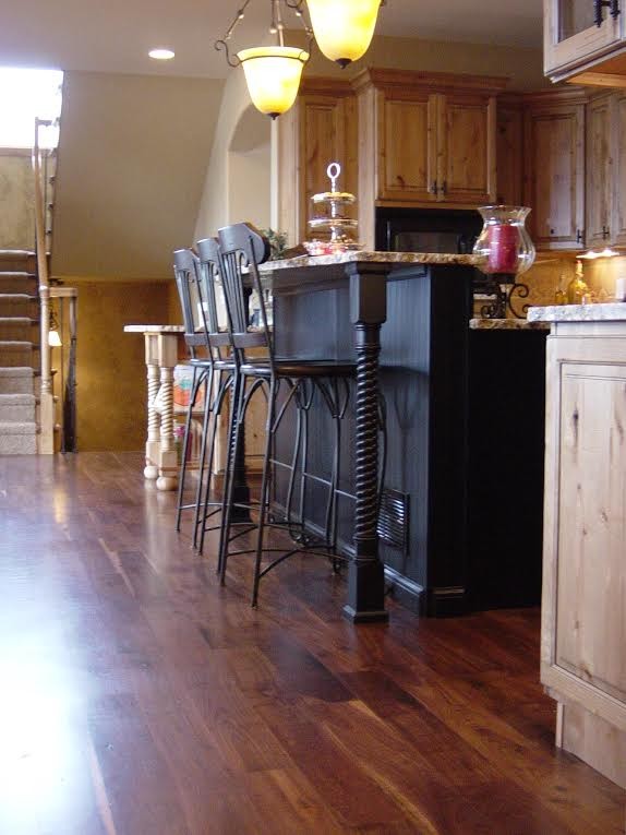 Photo of a country eat-in kitchen in Denver with medium hardwood floors.