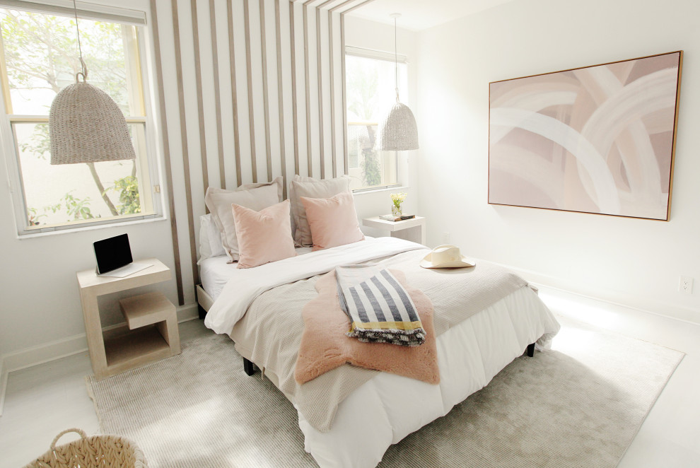 Inspiration for a beach style guest bedroom in Miami with laminate floors and wood walls.