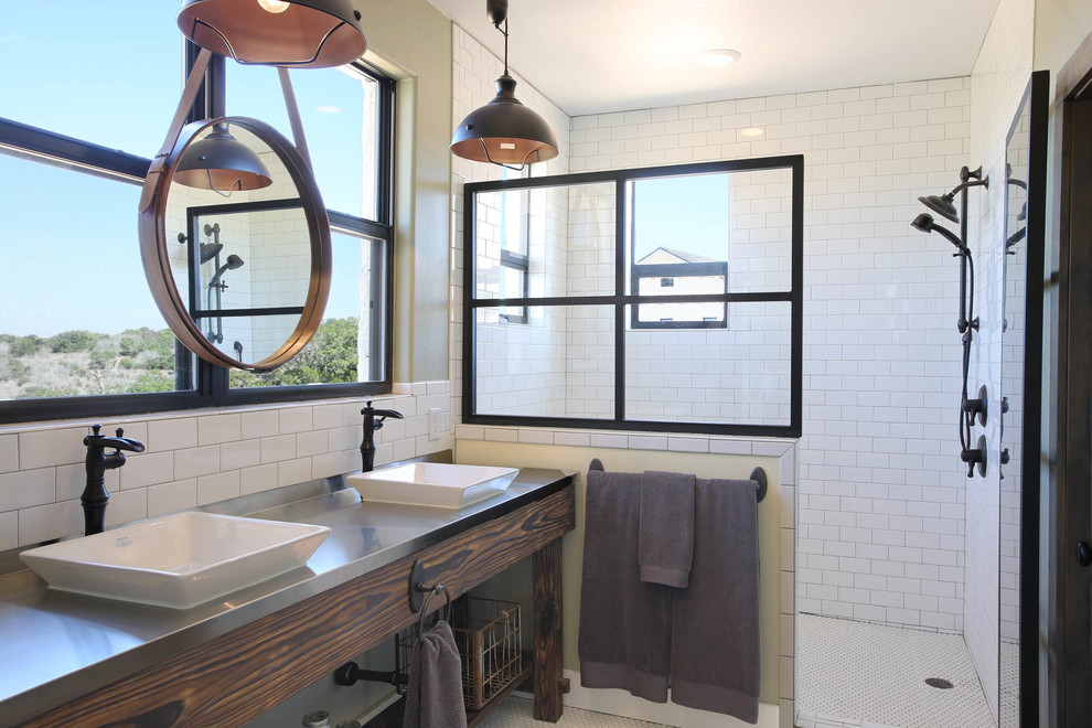 This is an example of a country bathroom in Austin with white tile, white walls, a vessel sink, stainless steel benchtops and a hinged shower door.