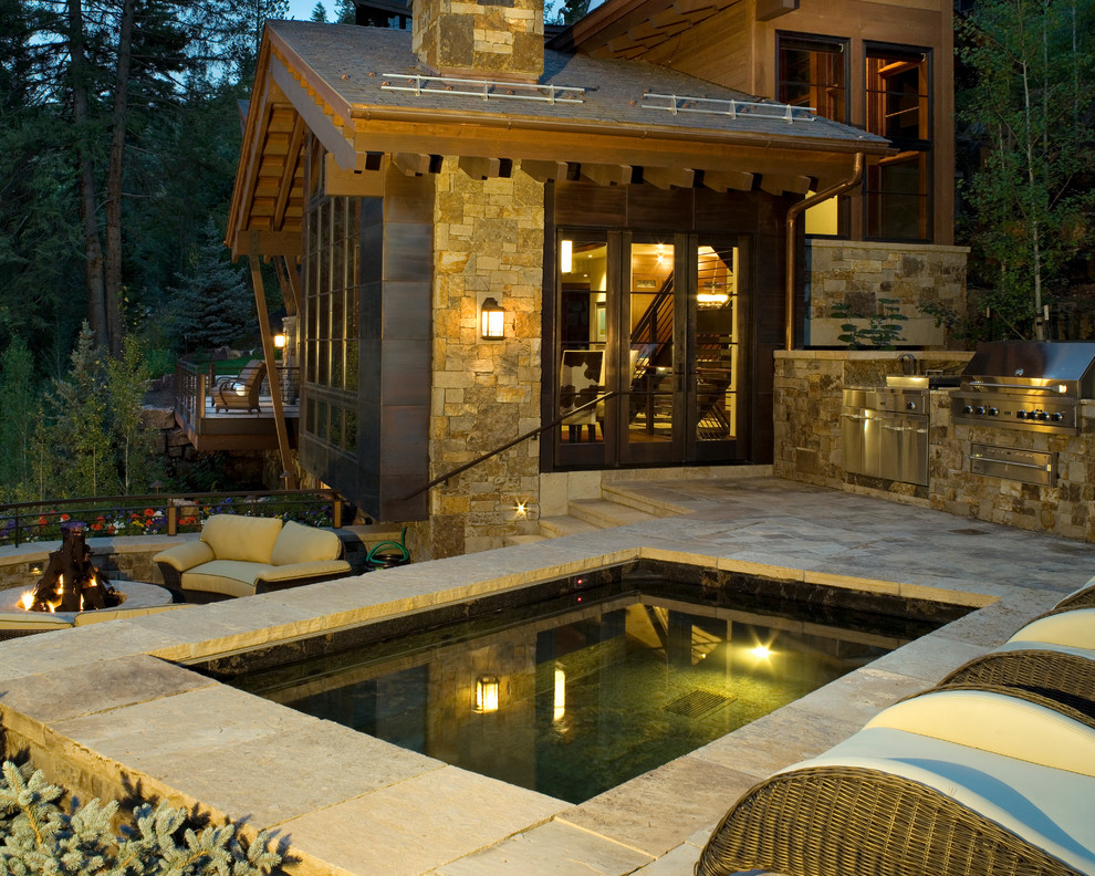 This is an example of a country pool in Denver with a hot tub.