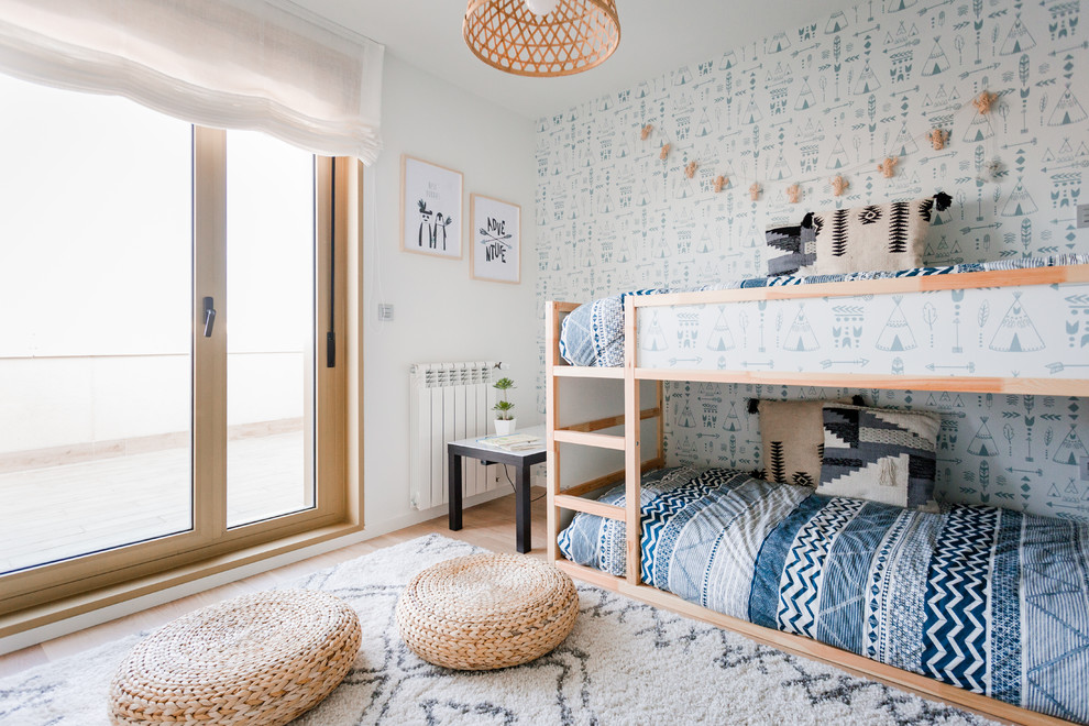 Inspiration for a beach style gender-neutral kids' bedroom for kids 4-10 years old in Other with multi-coloured walls and light hardwood floors.