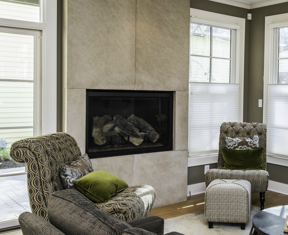 Modern living room in Indianapolis with a standard fireplace and a stone fireplace surround.