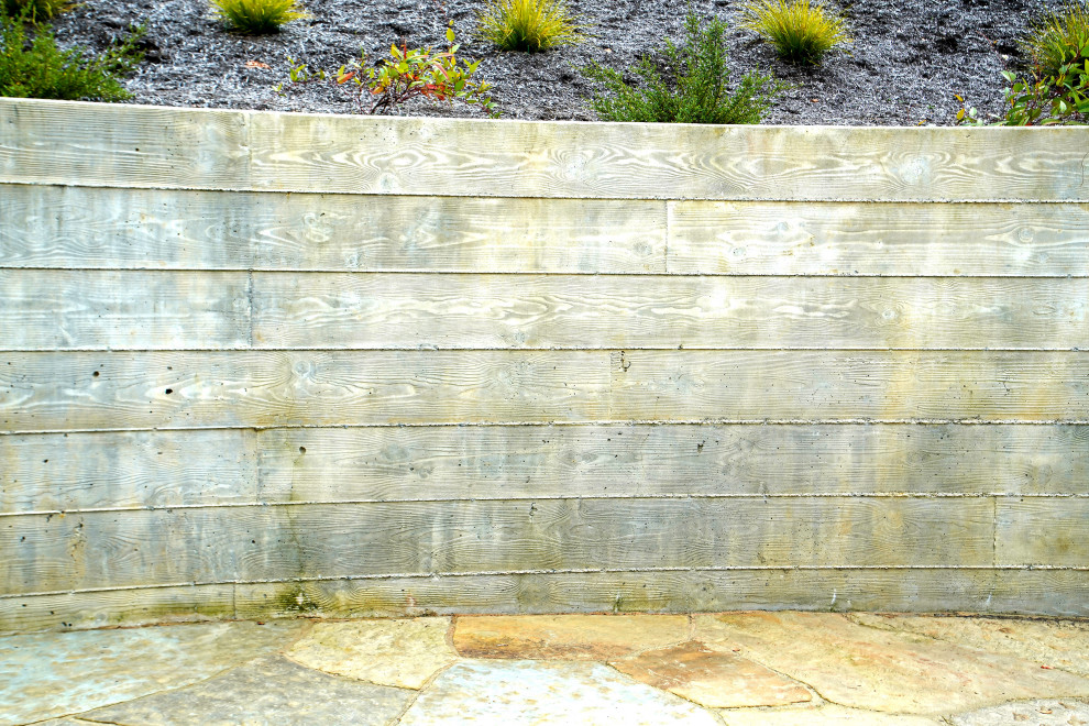 This is an example of a large industrial backyard shaded xeriscape in San Francisco with natural stone pavers.