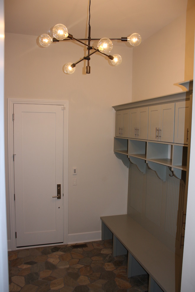 Large transitional slate floor mudroom photo in Chicago with white walls and a white front door