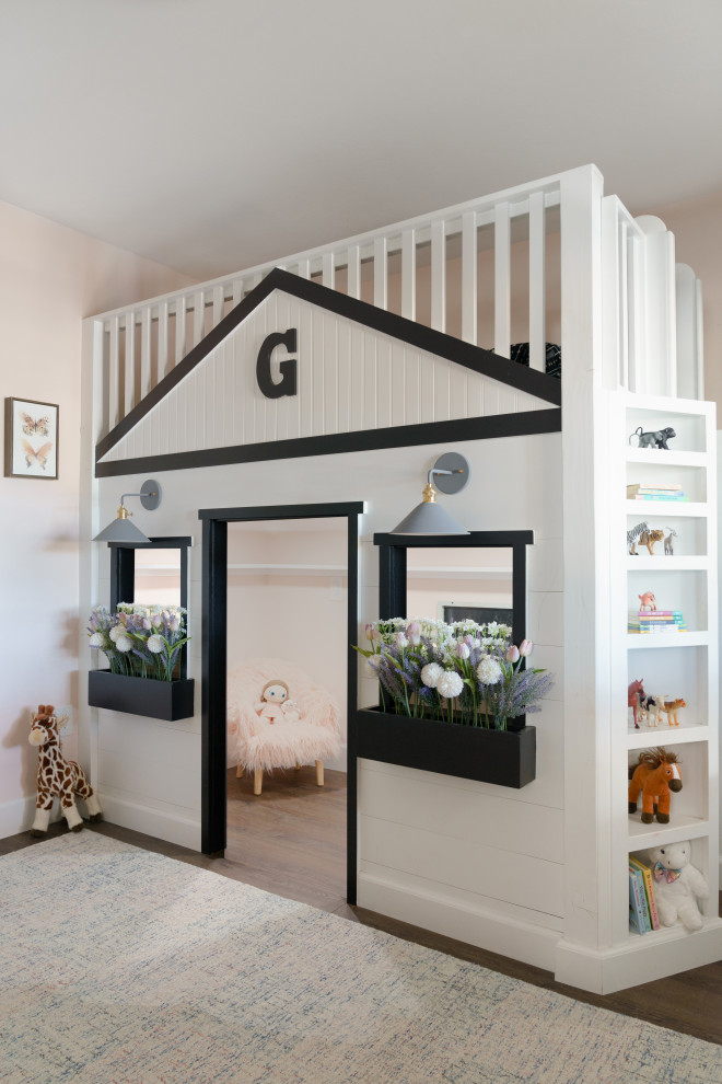 Design ideas for a mid-sized country kids' bedroom for kids 4-10 years old and girls in San Diego with pink walls, vinyl floors and brown floor.