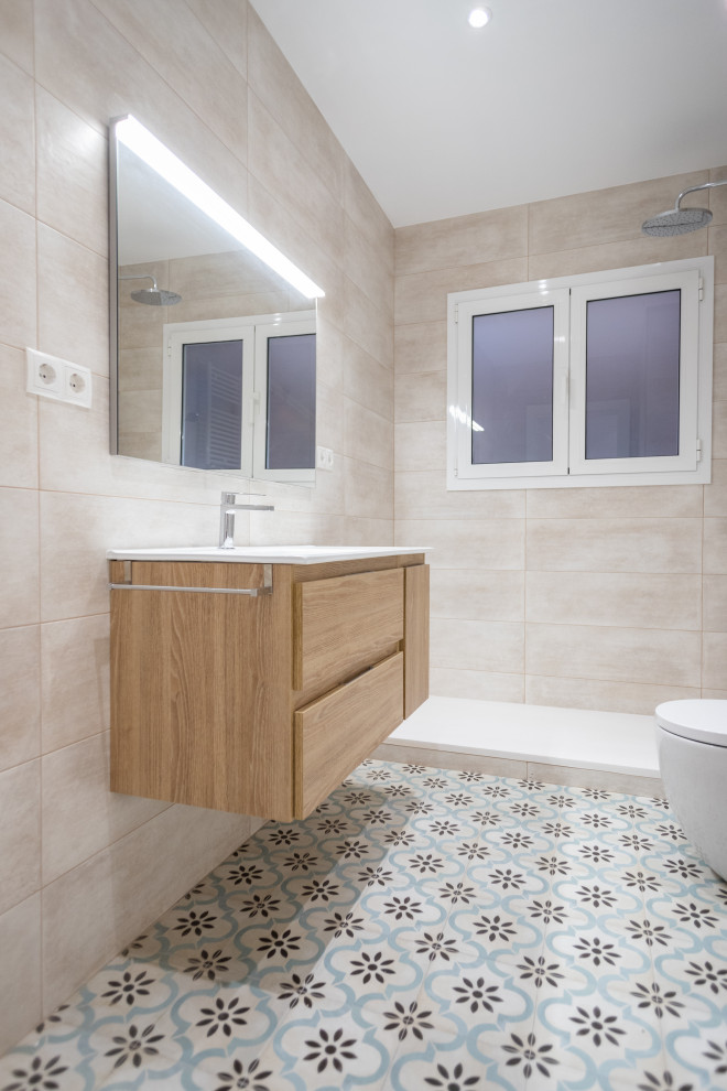 This is an example of a medium sized mediterranean ensuite bathroom in Barcelona with flat-panel cabinets, medium wood cabinets, a built-in shower, a one-piece toilet, beige tiles, ceramic tiles, ceramic flooring, a trough sink, beige floors, an open shower, white worktops, an enclosed toilet, a single sink and a floating vanity unit.