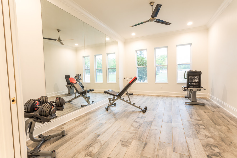 Design ideas for a mid-sized transitional home weight room in Other with grey walls and porcelain floors.