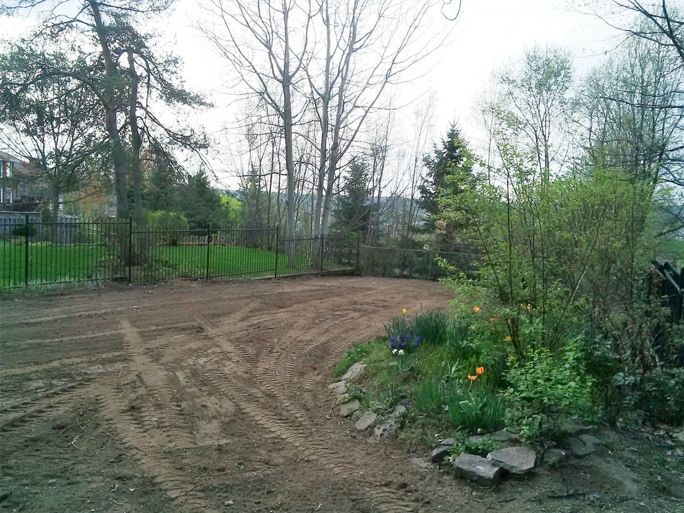 This is an example of a mid-sized full sun backyard landscaping.