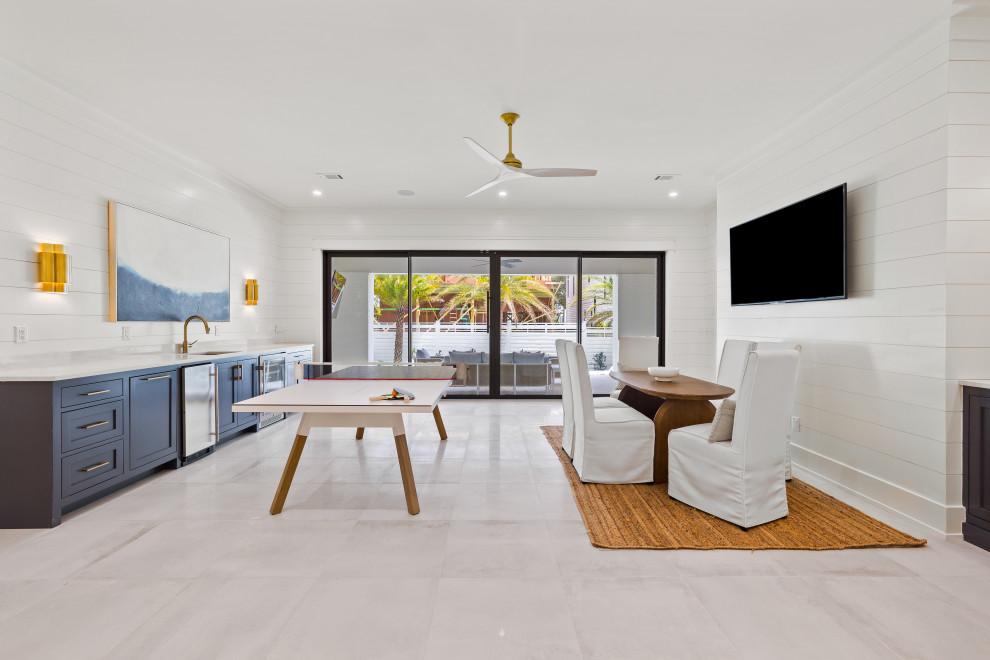 Inspiration for an expansive coastal games room in Other with white walls, porcelain flooring, white floors, tongue and groove walls and a wall mounted tv.